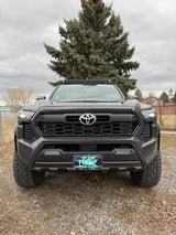 Front view: rugged dark gray Toyota pickup truck with light bar, Montana plate. An ideal rv rental for adventure.