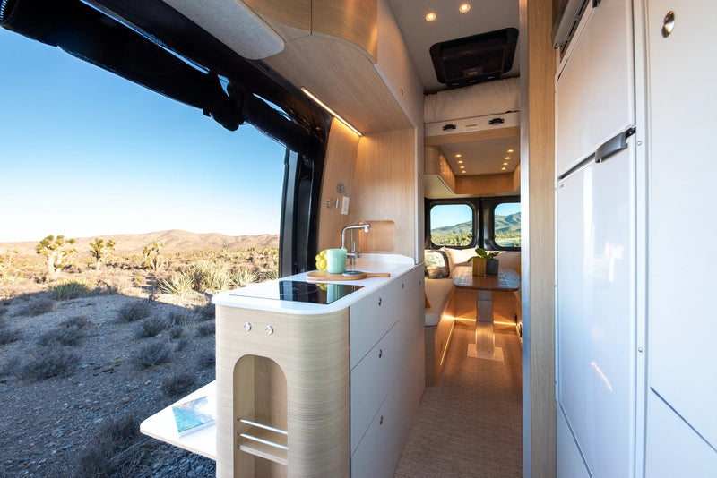 RV rental: Bright, modern interior featuring a kitchenette, dining area, and stunning desert landscape views. — photo 2