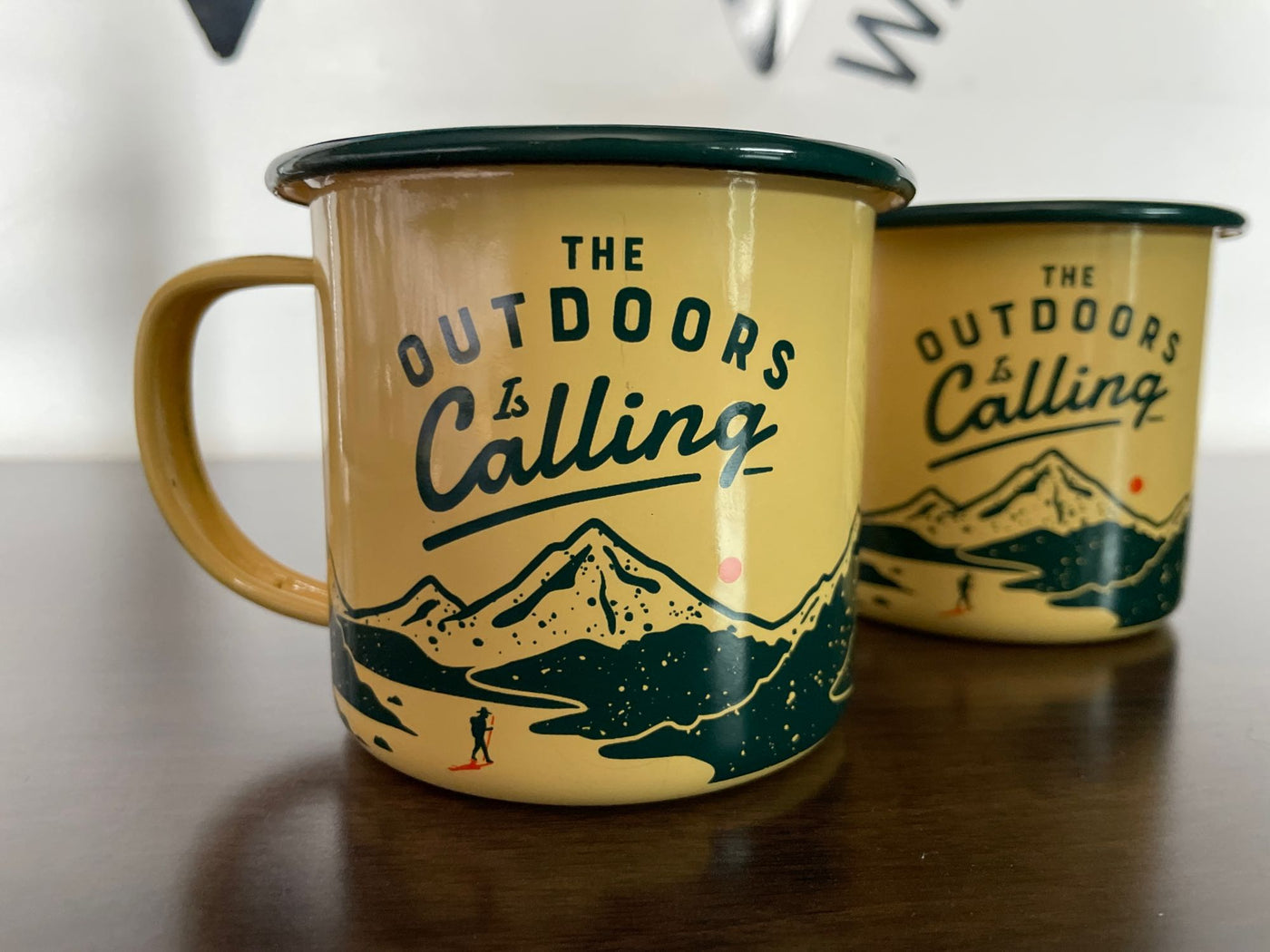  and a small kitchenette setup for comfortable mobile living.|Two yellow "Outdoors is Calling" enamel mugs — photo 3