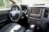 Driver's view inside an RV rental vehicle, showing the steering wheel, Kenwood screen, and dashboard controls.
