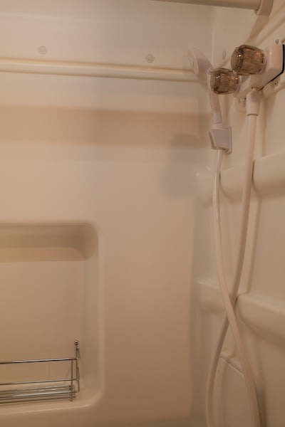  and rear bed for comfortable living.|RV rental interior showing a compact kitchenette with a cooktop — photo 16
