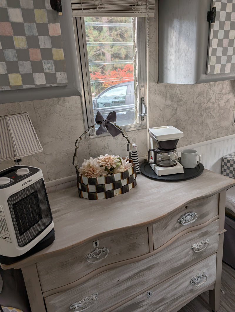 Cozy RV rental interior: dresser with heater, coffee maker, and floral decor near window. — photo 9