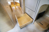 RV rental interior: Modern design with smart storage. Pull-out drawer and illuminated dinette offer comfort.