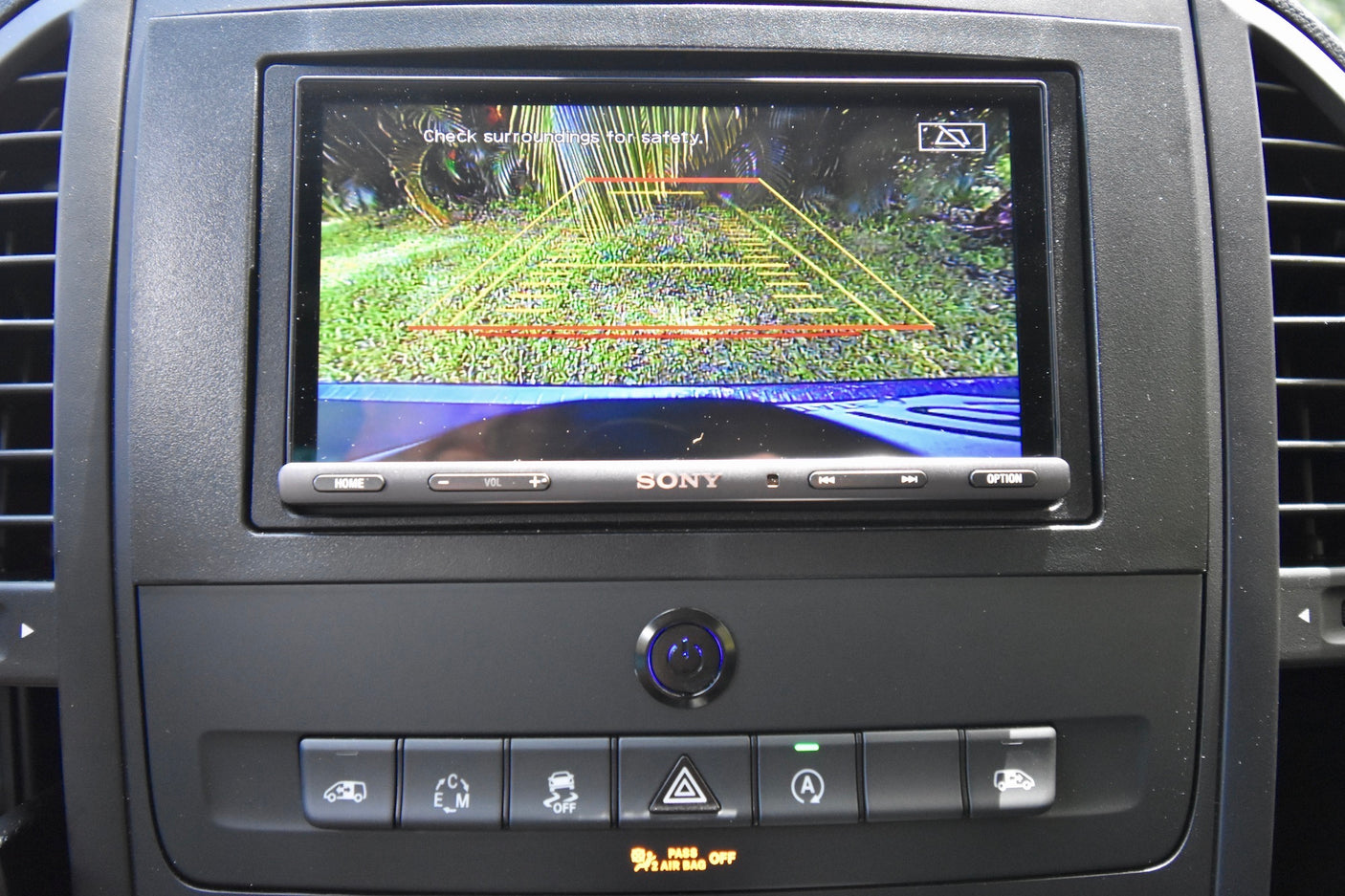 Dashboard of an RV rental showing a rearview camera feed on a Sony display, with safety guidelines and controls.