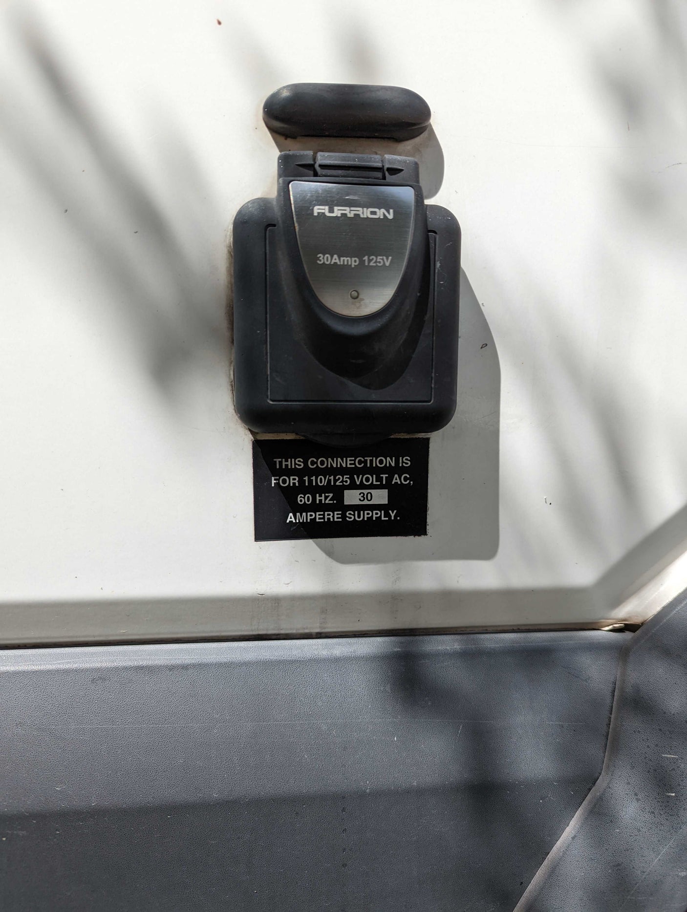 RV power inlet: Furrion 30 Amp, 125V connection on an rv rental. Shows electrical specifications.