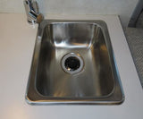 This rv rental features a compact stainless steel sink and chrome faucet on a white countertop, ready for use.