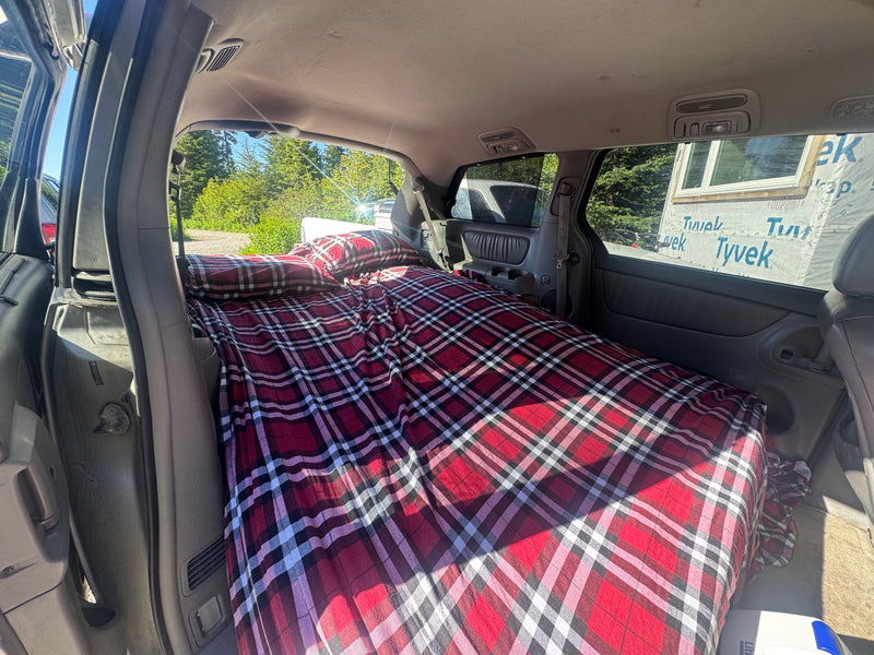  and SUV on a gravel road next to a building wrapped in Henry R-TECH.|Dirty silver minivan with Thule cargo box — photo 7