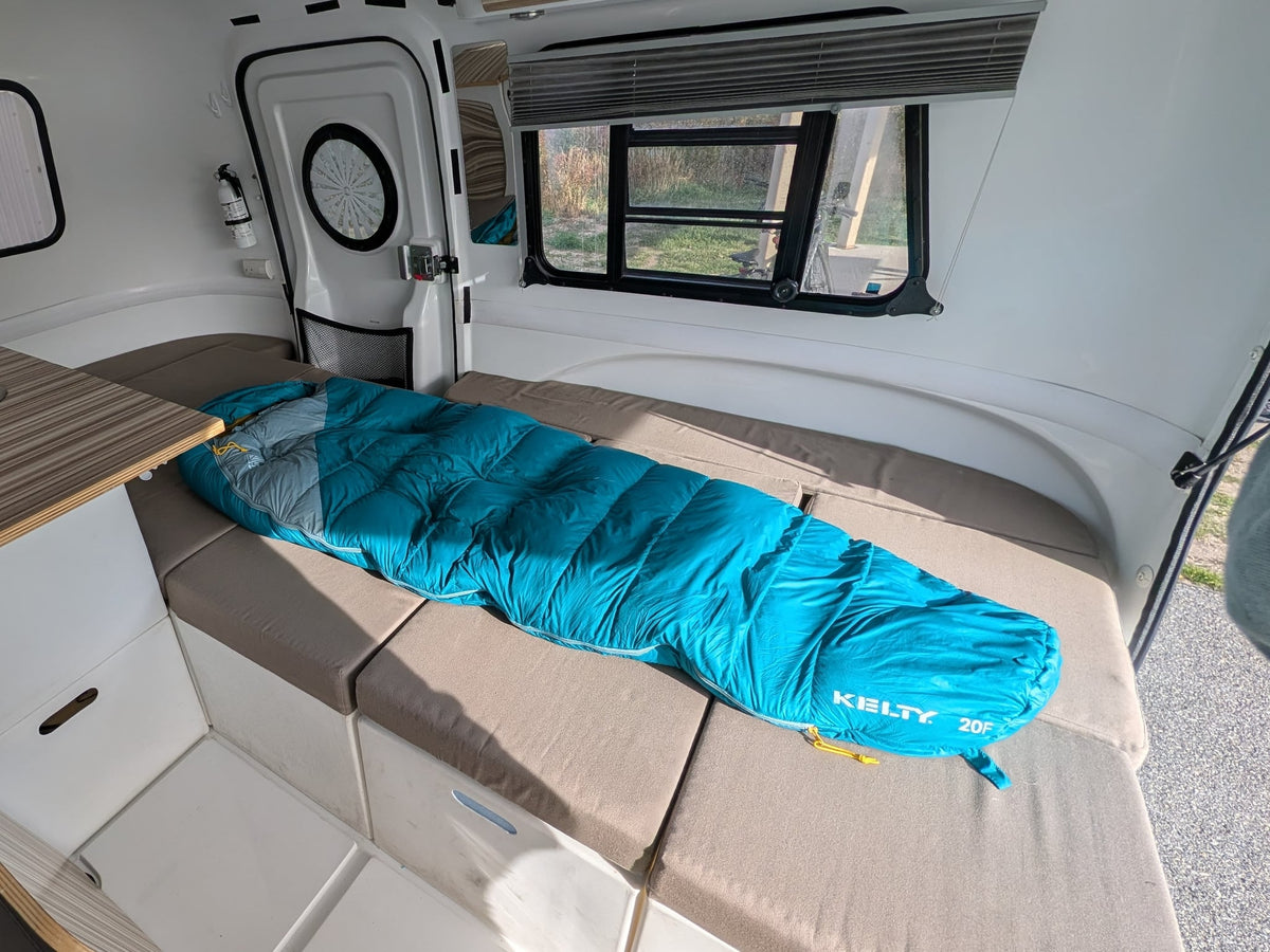  with a bike nearby.|RV rental interior: a compact — photo 4