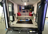 RV rental interior: versatile living space with convertible sofa, entertainment, and rear ramp access for gear.