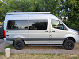 Sleek silver camper van, equipped for adventure, ready for your next rv rental trip. Features Thule awning & rugged tires.