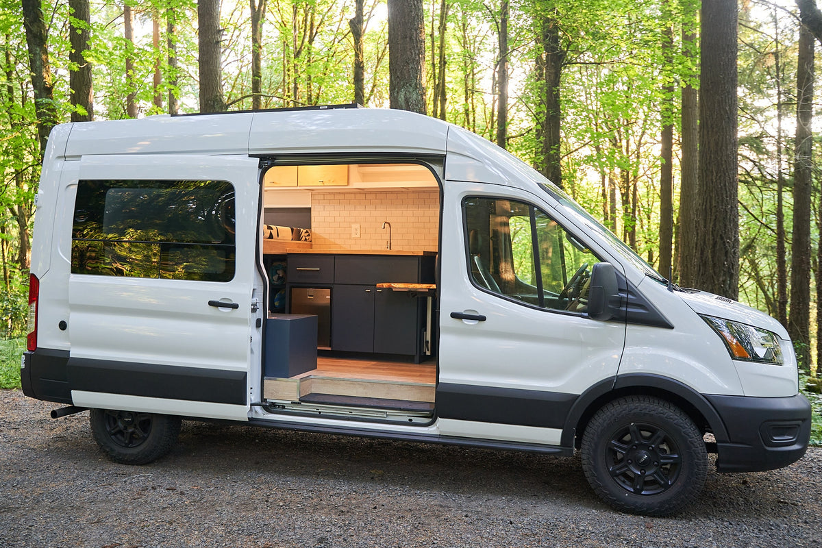 Modern white RV rental camper van with open door