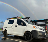 White surf van, a perfect RV rental alternative, parked under a stunning double rainbow.