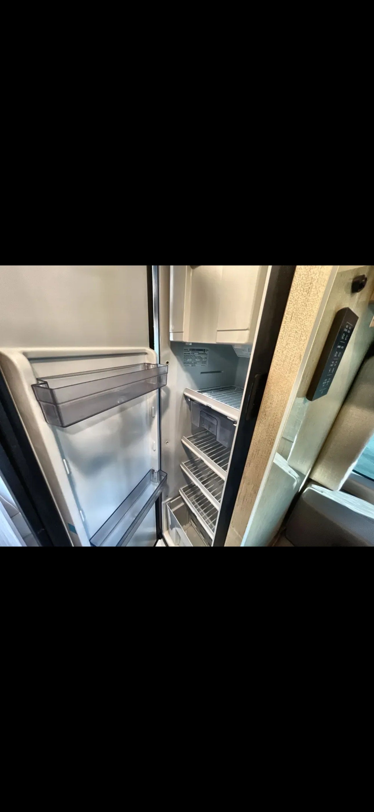 RV rental: The clean, open refrigerator shows shelves, door bins, and drawers, ready for your travel. — photo 5