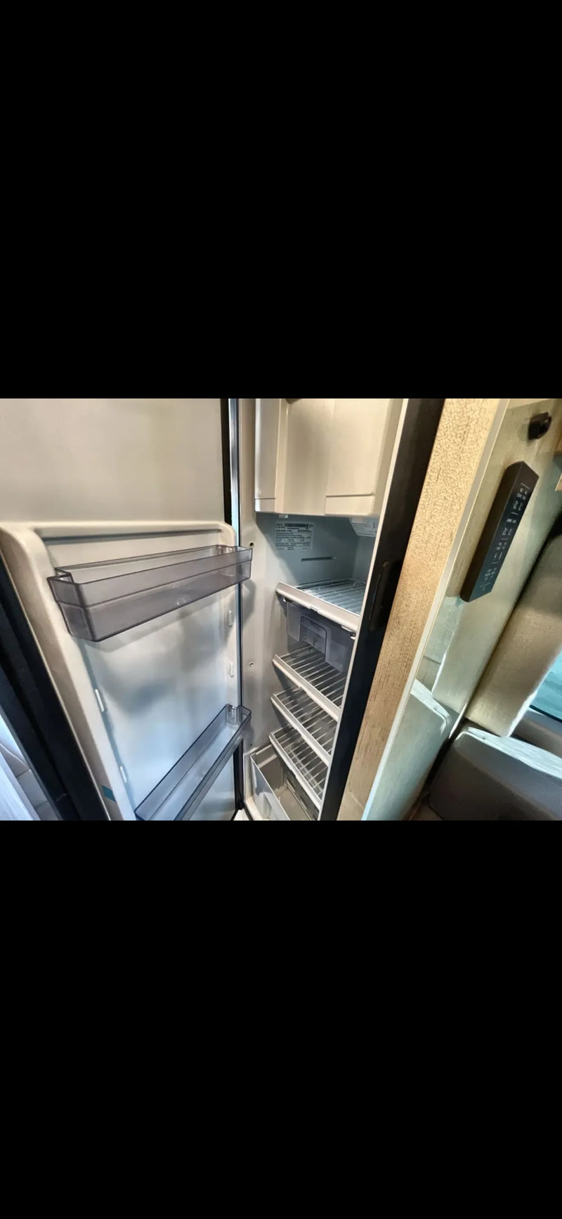 RV rental: The clean, open refrigerator shows shelves, door bins, and drawers, ready for your travel. — photo 5