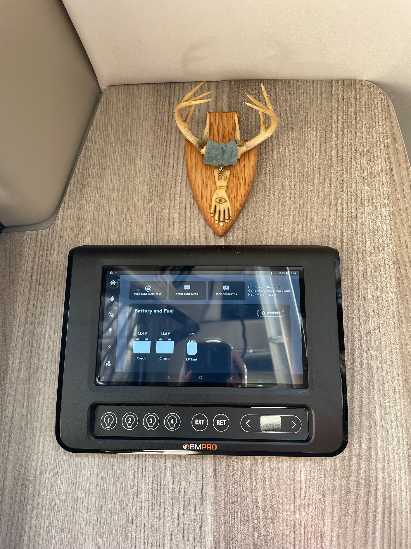 RV rental tech: BMPro panel monitors battery, fuel, and generator, topped by decorative antlers.