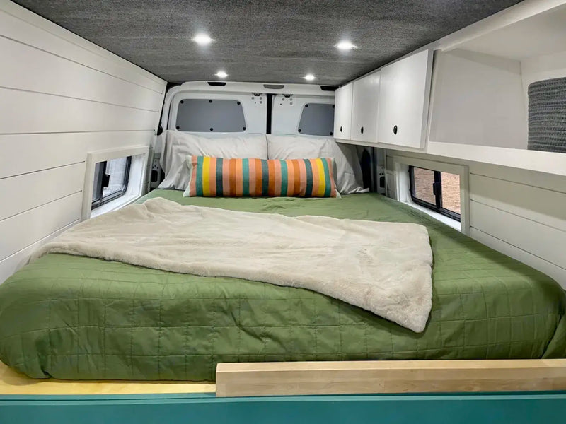  stylish layout.|White camper van parked in a lush forest campsite. Perfect for your next RV rental adventure!|Inside a modern **rv rental** van conversion: teal kitchen — photo 5