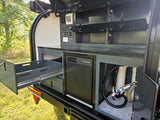 Explore this RV rental's versatile outdoor kitchen with Freucamp fridge, pull-out storage, and full utility panel.