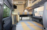 Explore this cozy RV rental interior with its flexible seating, convertible bed, compact kitchen, and scenic windows.