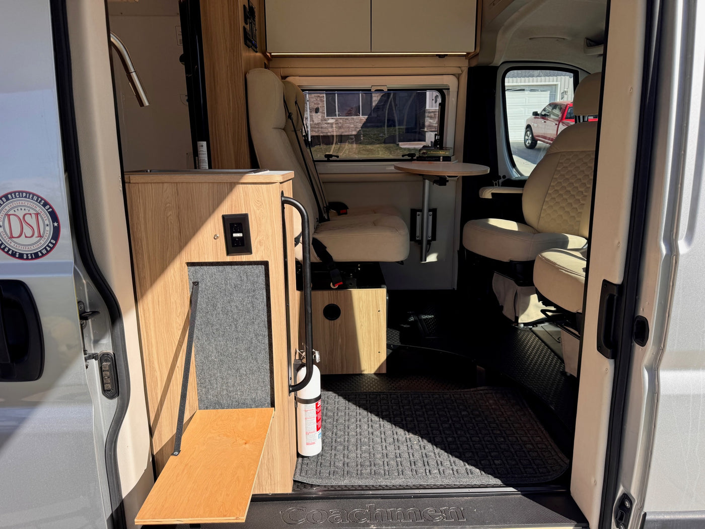 Coachmen RV rental interior: A compact camper van with a kitchenette, swiveling seats, and a small table, ready for adventure. — photo 7