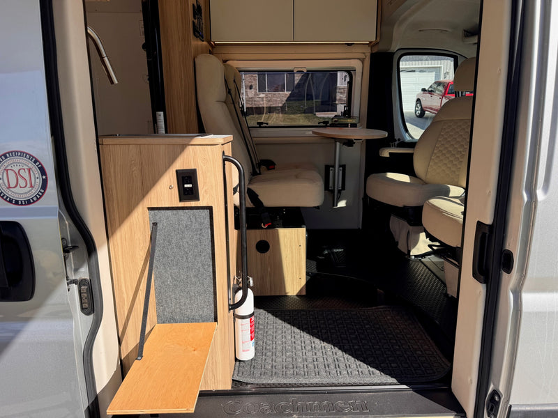 Coachmen RV rental interior: A compact camper van with a kitchenette, swiveling seats, and a small table, ready for adventure. — photo 7