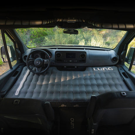 RV rental adventure! A custom LUNO air mattress transforms this Mercedes van's front cabin into a comfortable sleeping area.