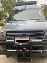 Gray Mercedes Sprinter adventure van, ideal for rv rental. Shows an off-road front bumper setup with WARN branding and roof rack.