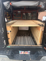 RV rental? Explore this custom truck camper setup with built-in storage & sleeping platform, perfect for overlanding.