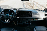 Inside a modern RV rental: A detailed view of the Mercedes-Benz dashboard, steering wheel, and cabin controls.