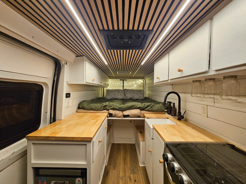  ideal for your RV rental or camping adventure.|Compact RV rental kitchen features white cabinets — photo 14