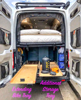 RV rental interior view: elevated bed, extending bike tray, & additional storage show a well-equipped camper van.
