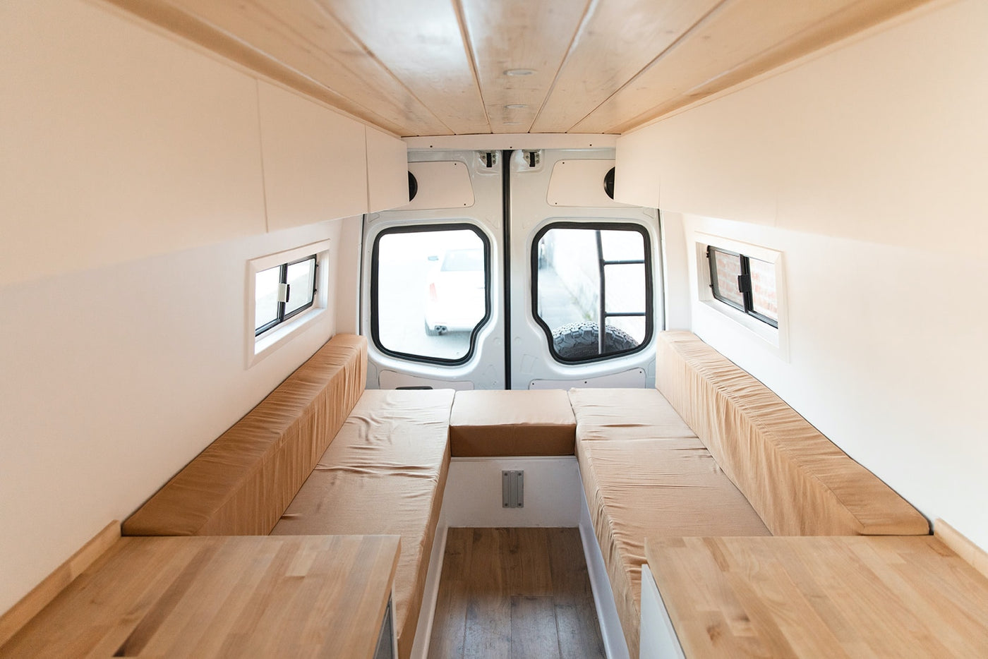  bright camper van interior showcasing a kitchenette with wood counters — photo 4