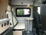  and control panels.|An RV rental's rear interior with a fold-out bed