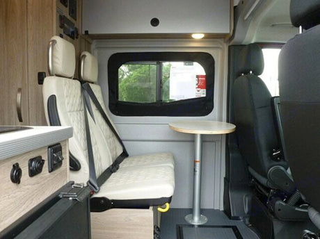  and control panels.|An RV rental's rear interior with a fold-out bed