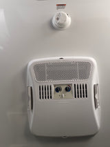 RV rental interior: Dometic AC unit with heat/cool controls and a smoke alarm, crucial for travel trailer safety.
