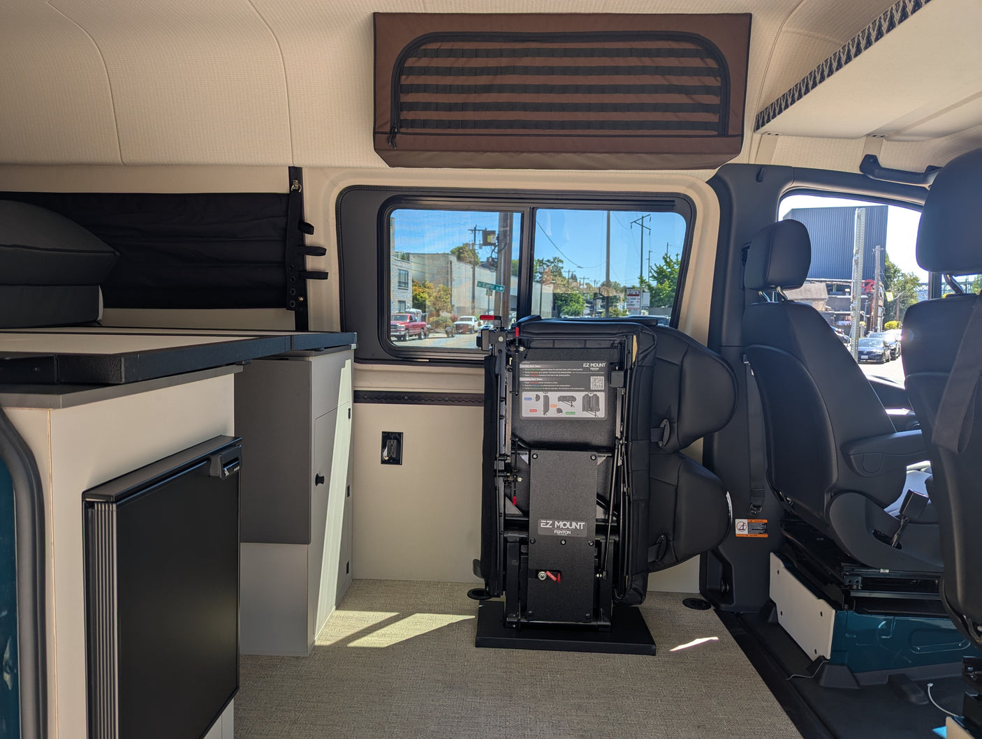 Inside this RV rental: versatile EZ Mount seating system, compact kitchen, and ample overhead storage for adventures.
