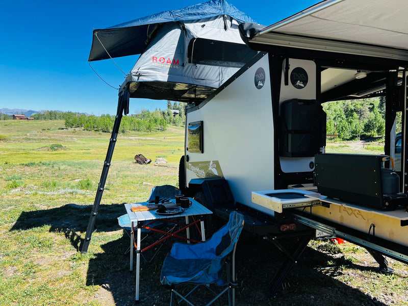 ROAM rooftop tent on a Taxa TigerMoth rv rental, with a mobile kitchen setup for outdoor camping in a scenic landscape. — photo 8