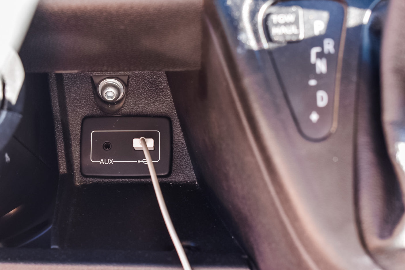 Inside an RV rental: Console details showing an AUX audio port, USB charging port, and 12V outlet for convenient connectivity.