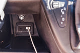 Inside an RV rental: Console details showing an AUX audio port, USB charging port, and 12V outlet for convenient connectivity.