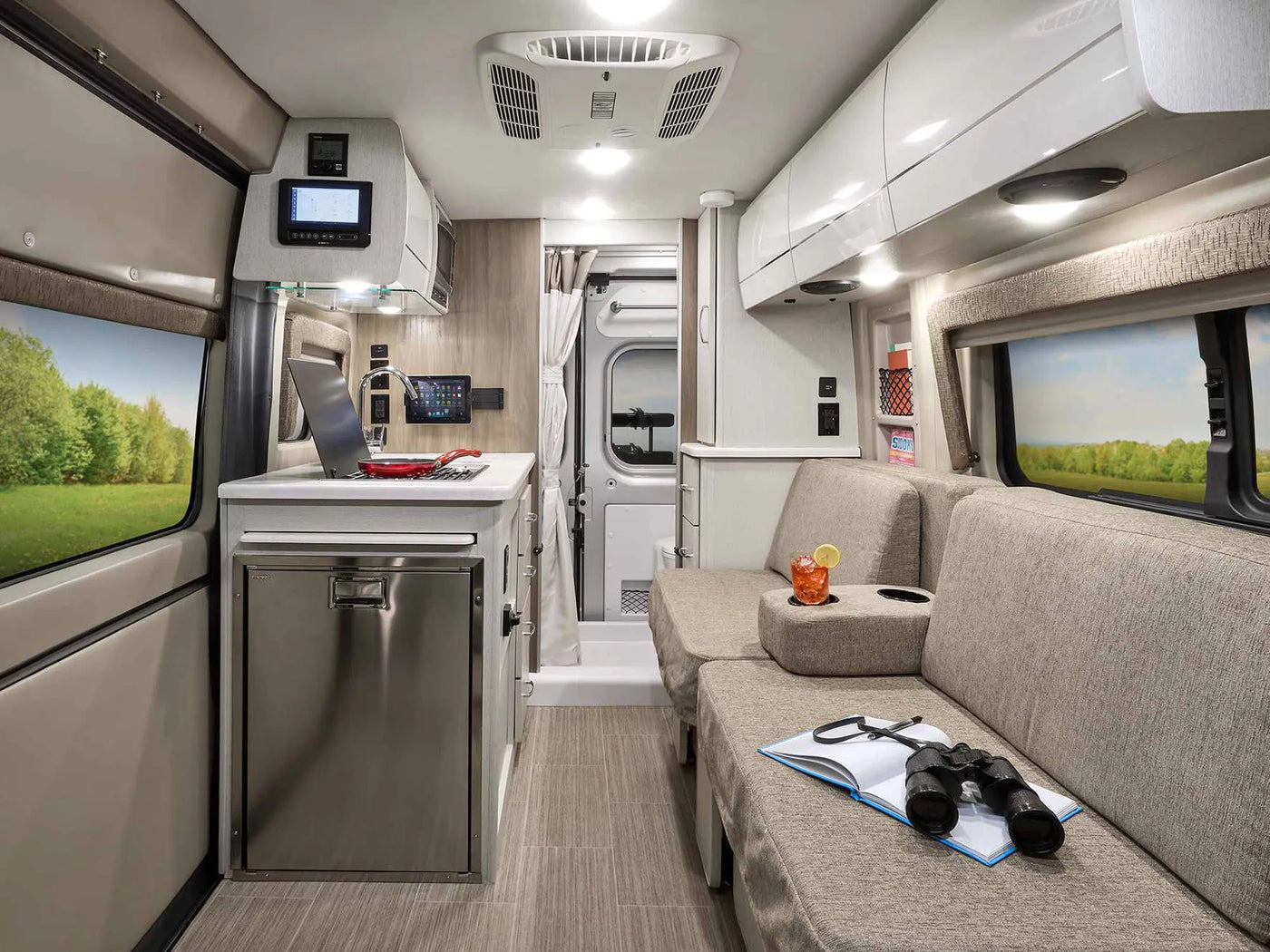  parked in a bright outdoor lot.|Front view of a dark gray Ram ProMaster camper van — photo 8