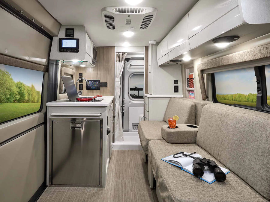 RV rental's modern mobile living space: compact kitchen, cozy lounge, and scenic views for travel.