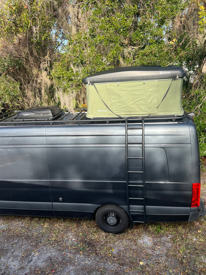 This dark gray RV rental camper van, equipped with a Trusthmade rooftop tent and Dometic unit, has a side ladder. — photo 16