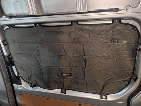 Quilted insulation panel for an RV rental van window, providing privacy and temperature control.
