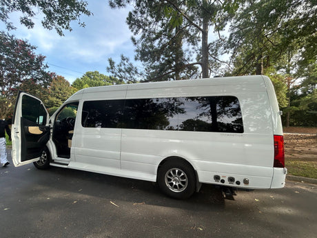 White luxury Mercedes-Benz Sprinter RV rental, an "Ultimate Toys" conversion, with its doors open for entry.