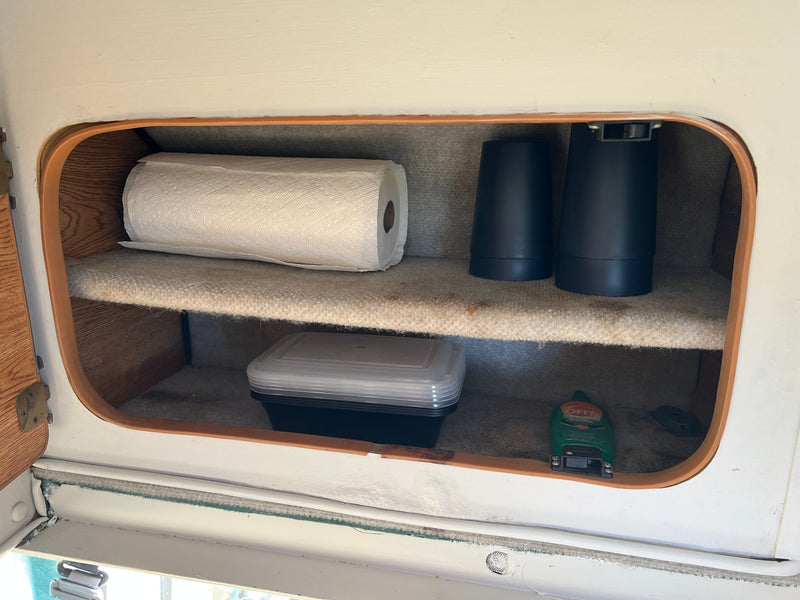  and overhead cabinets.|Inside an RV rental: a compact galley kitchen with dark cabinets — photo 17