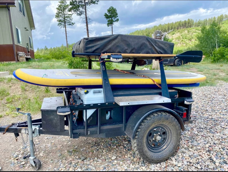  against a mountain backdrop.|Outdoor kitchen setup on an overlanding trailer — photo 2