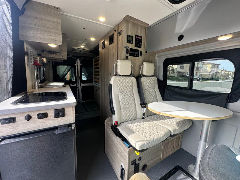  & overhead storage.|This RV rental's compact kitchen boasts a sink — photo 7