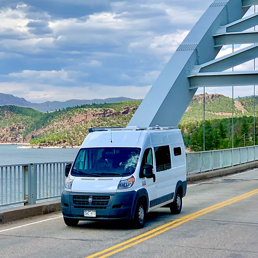  ideal for an RV rental. Features control knobs and a vent pipe.|An RV rental van parked at a scenic overlook in a national forest