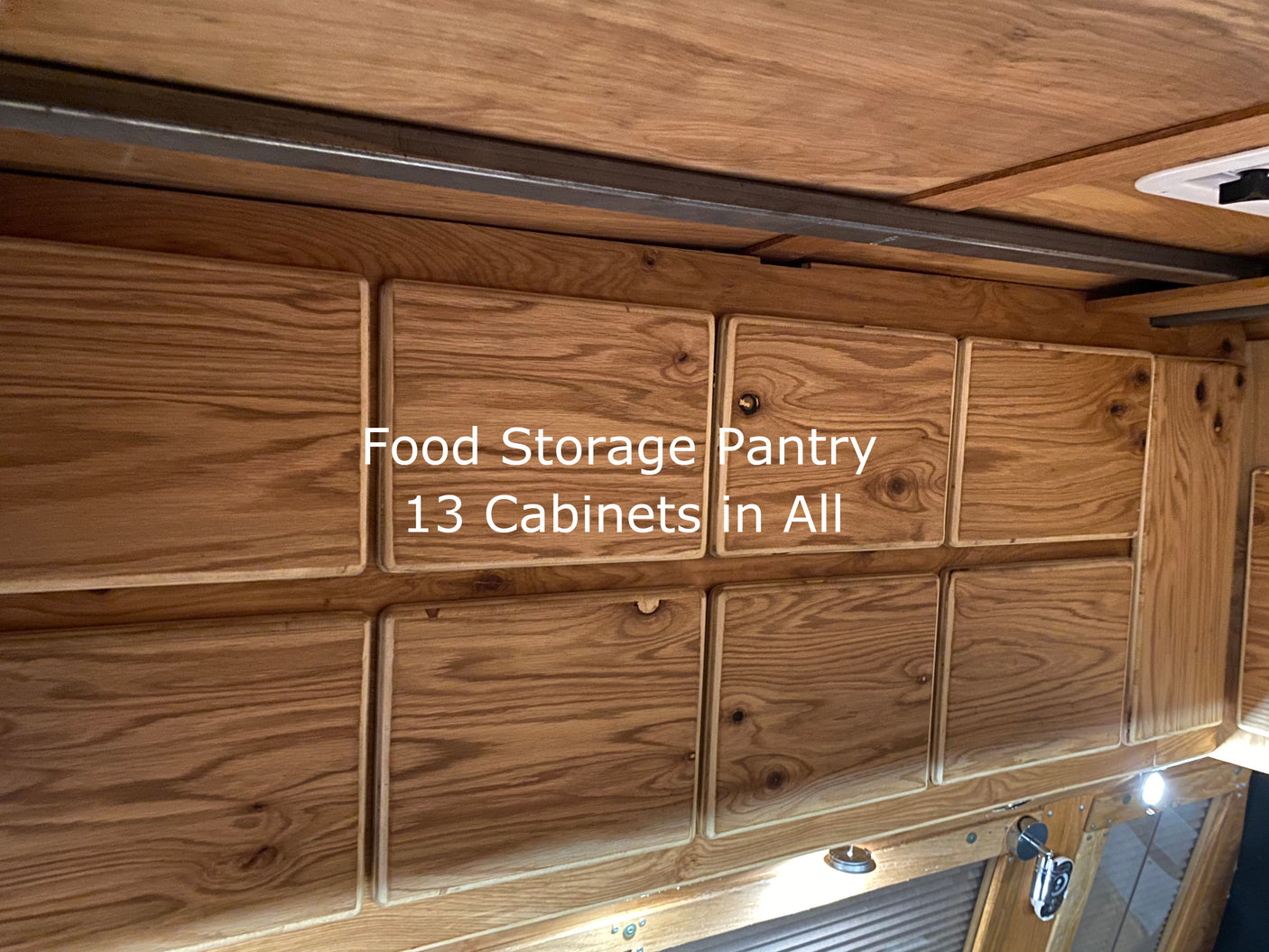This RV rental's food storage pantry boasts 13 custom wooden cabinets for efficient, organized travel storage.