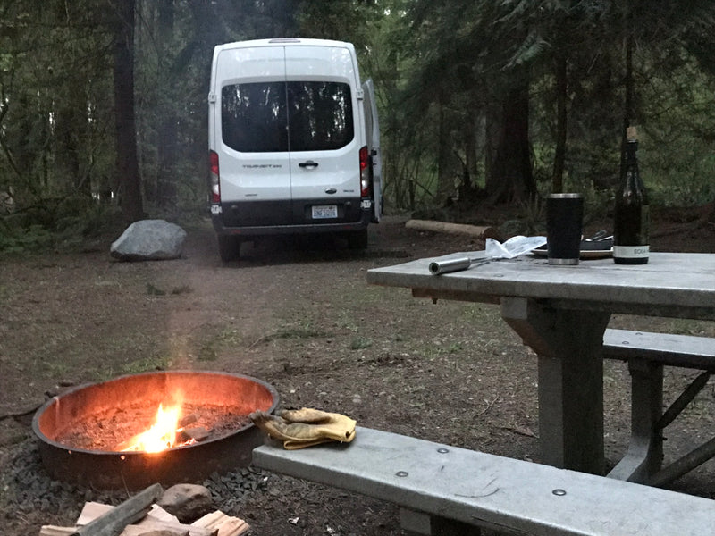 RV rental campsite nestled in the woods with a cozy campfire and picnic table, perfect for outdoor adventure. — photo 3