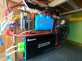 RV rental electrical system: Renogy 2000W inverter, Victron Lynx distributor, Renogy charge controller, and fuse box setup.